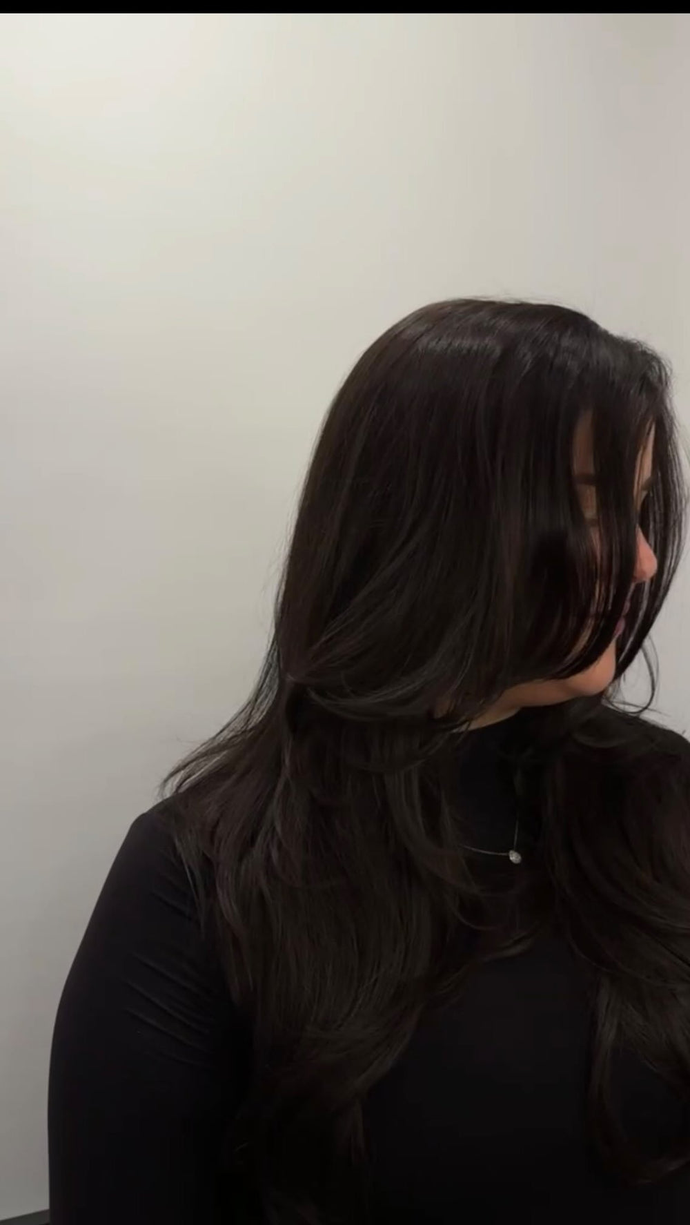 Long dark brunette layered haircut at Dubé New York, New York NY