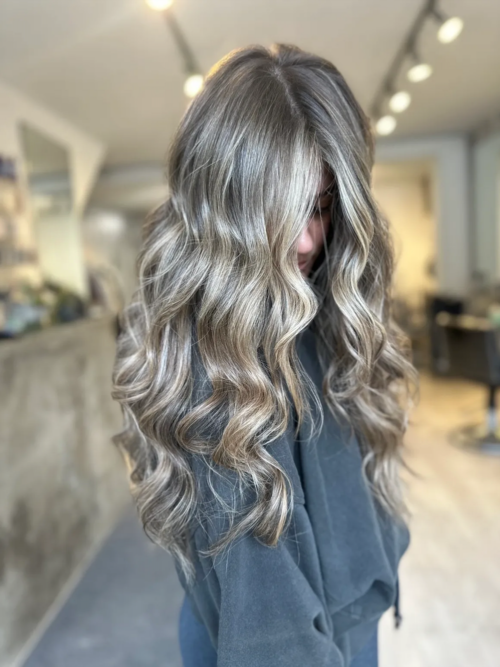 Silver platinum blonde with loose waves at Dubé New York, New York NY